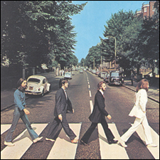 The Beatles walk across Abbey Road.